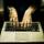 An image of transparent hands hovering over a keyboard.